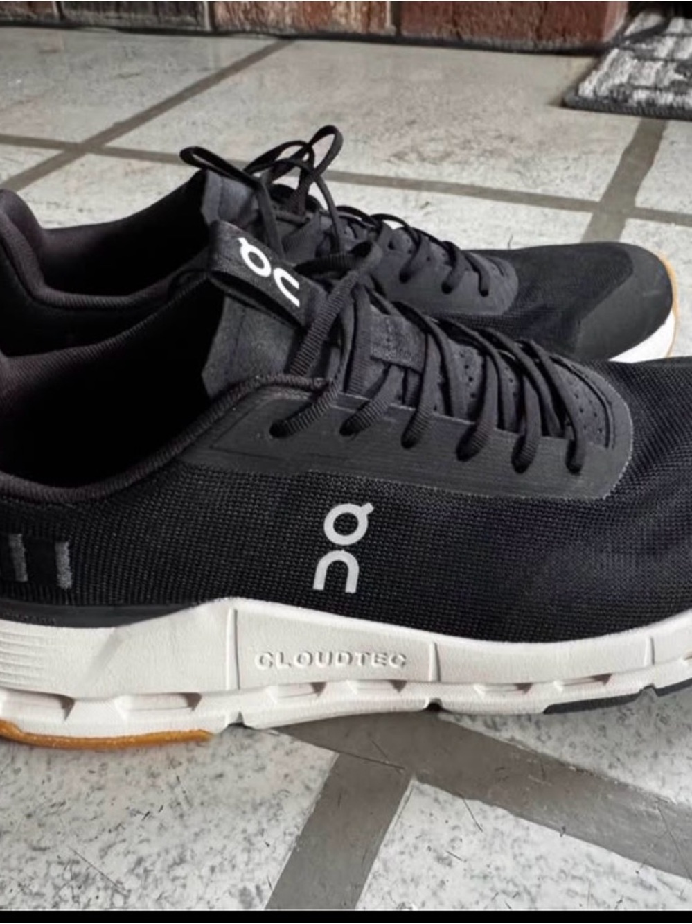 On Running women Athletic Shoes in Black and White with Gum Outsole
